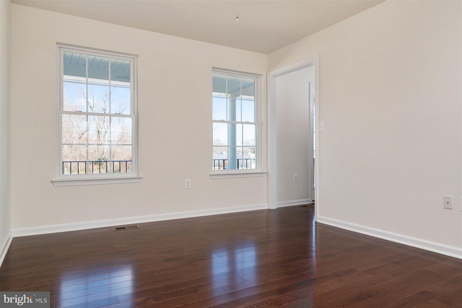 7412 Rossville Boulevard Rosedale, MD 21237 - Photo 10 of 37 a view of an empty room with wooden floor and a window