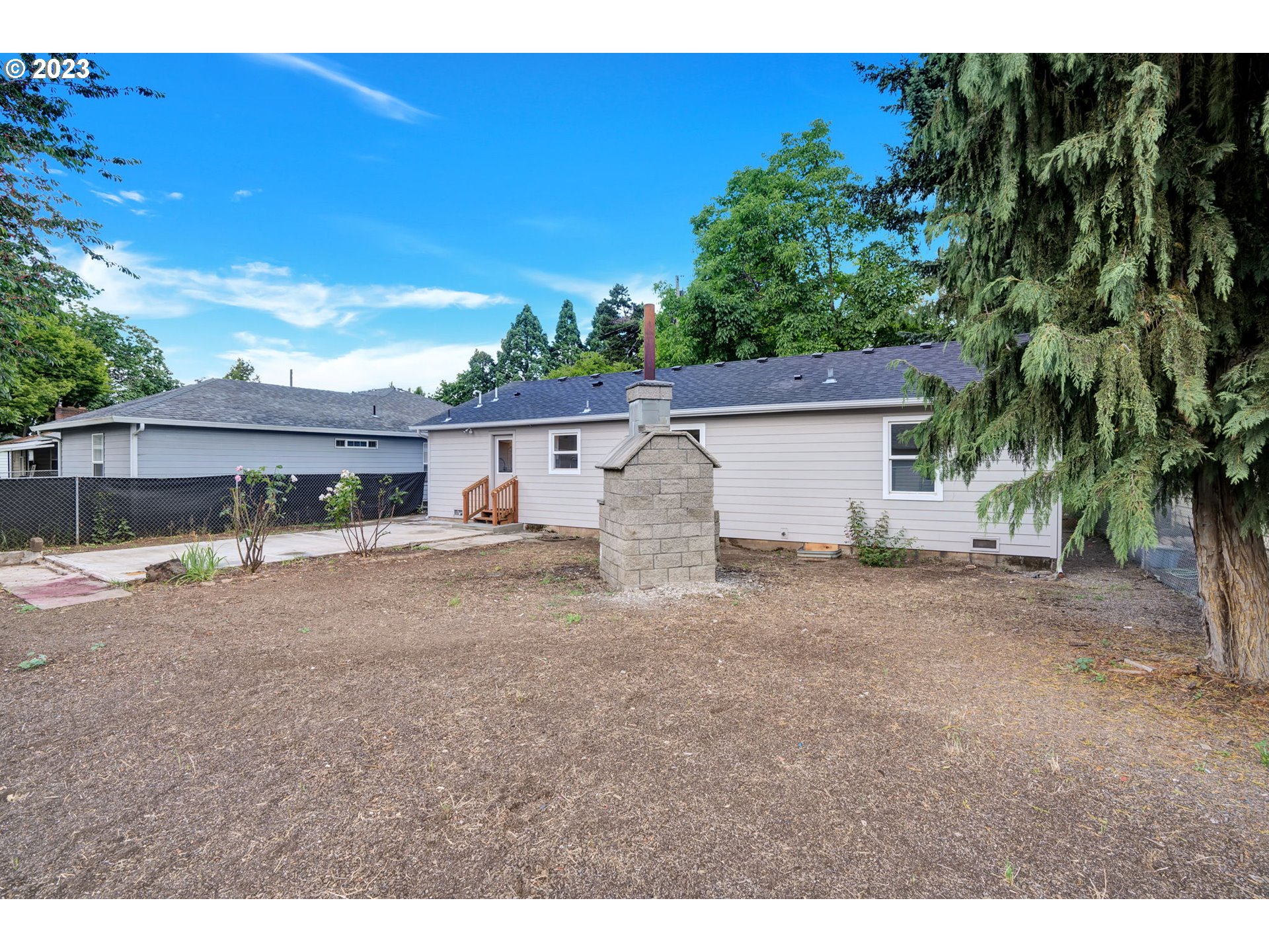 840 High Street Woodburn, OR 97071 - Photo 18 of 18 a view of a house with backyard and a tree