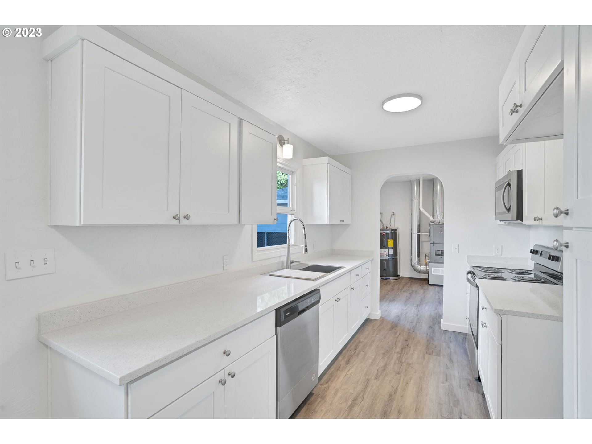 840 High Street Woodburn, OR 97071 - Photo 6 of 18 a kitchen with a sink stove and cabinets