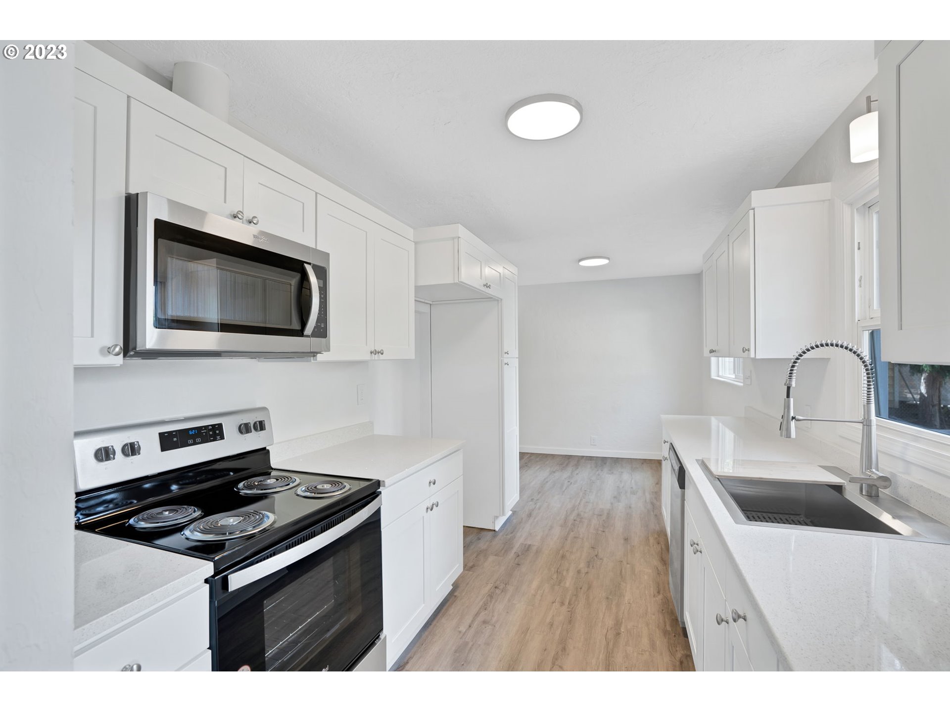 840 High Street Woodburn, OR 97071 - Photo 7 of 18 a kitchen with stainless steel appliances a sink a stove top oven a counter space and cabinets