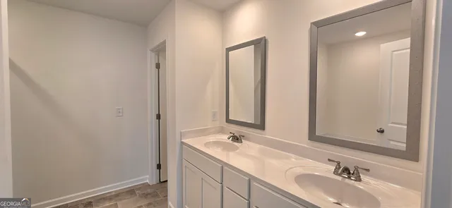 a bathroom with a tub sink and mirror