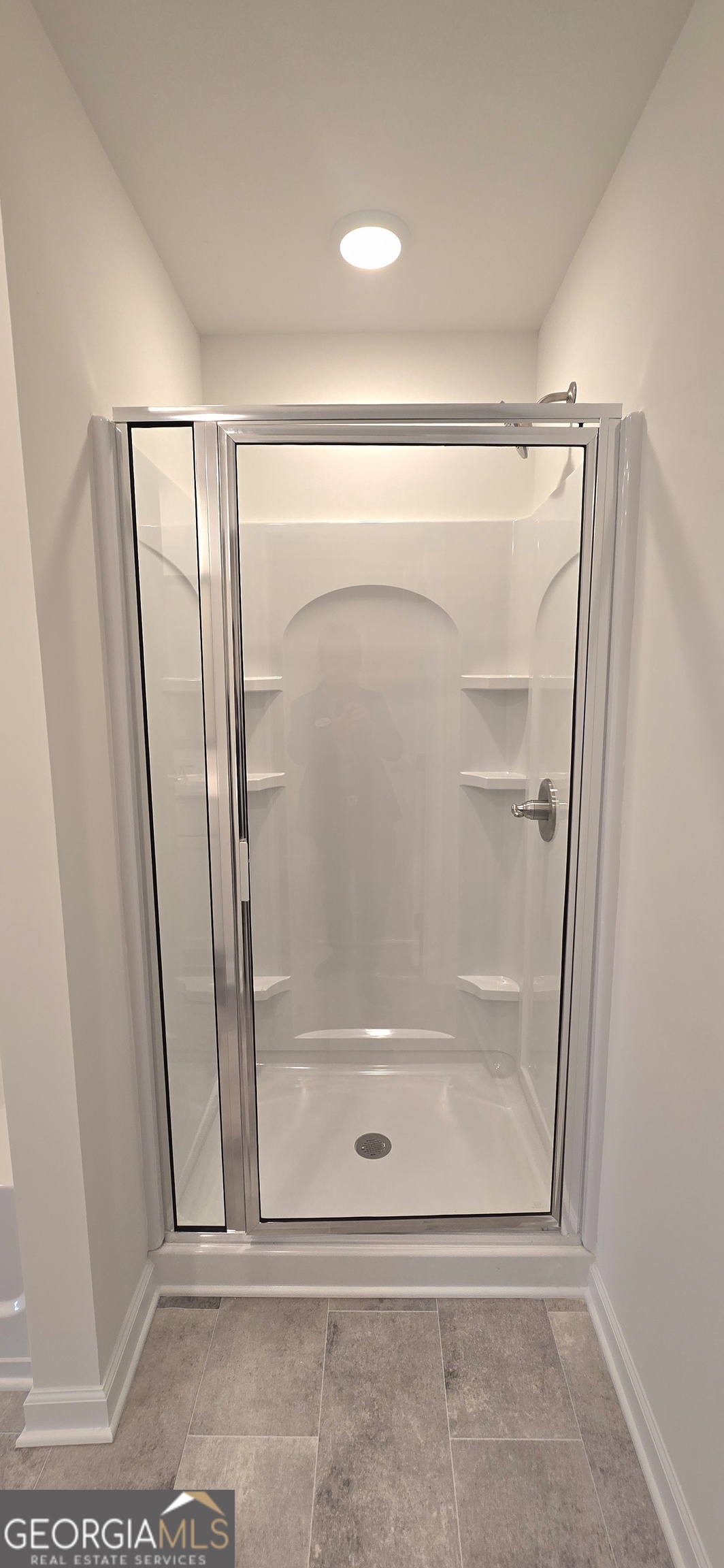 34 Russet Way Newnan, GA 30263 - Photo 22 of 38 a bathroom with a glass shower door