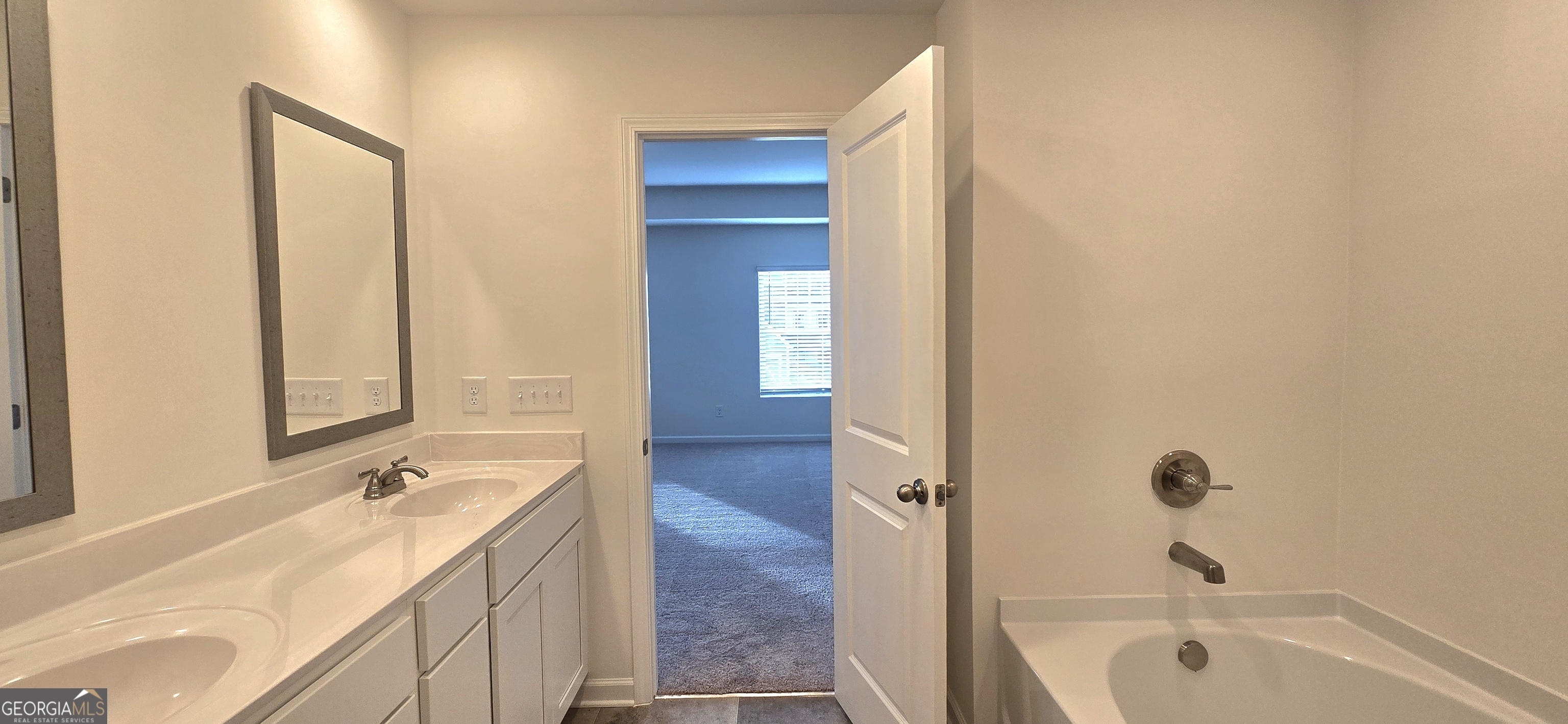 34 Russet Way Newnan, GA 30263 - Photo 24 of 38 a bathroom with a tub sink and mirror