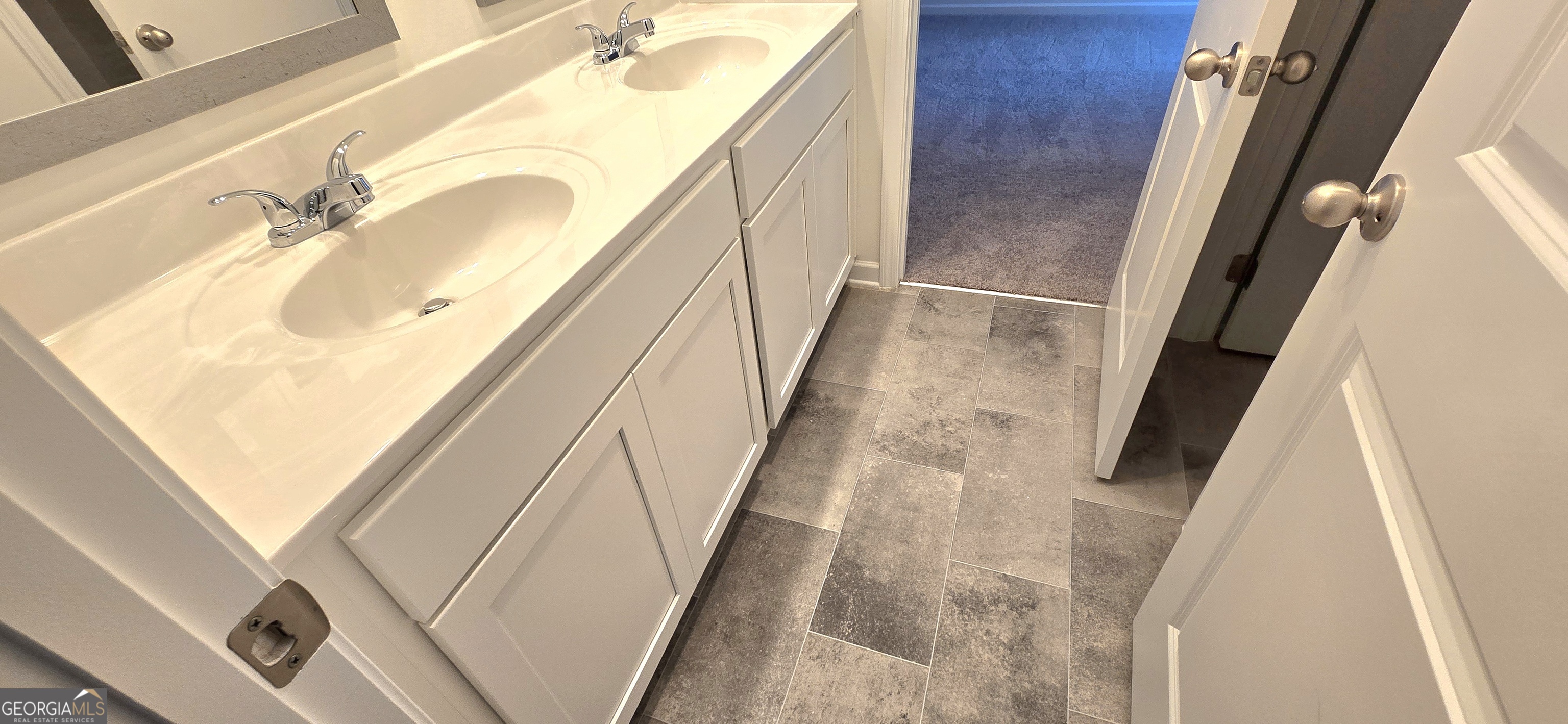 34 Russet Way Newnan, GA 30263 - Photo 28 of 38 a bathroom with a sink a mirror and a shower