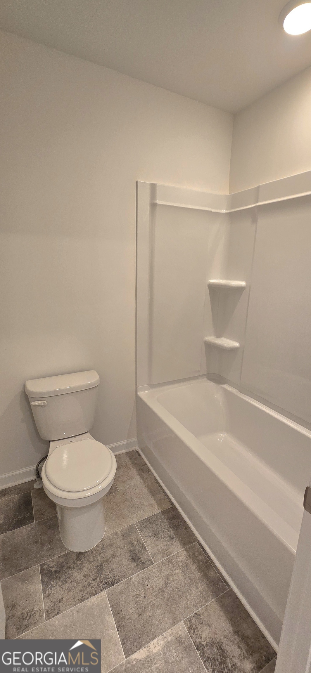 34 Russet Way Newnan, GA 30263 - Photo 29 of 38 a bathroom with a toilet and a bathtub