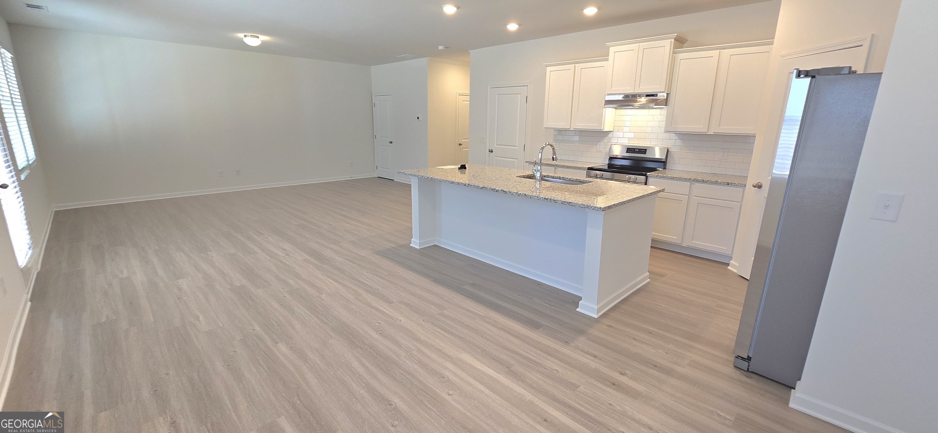 34 Russet Way Newnan, GA 30263 - Photo 8 of 38 a kitchen with stainless steel appliances cabinets a sink and a stove
