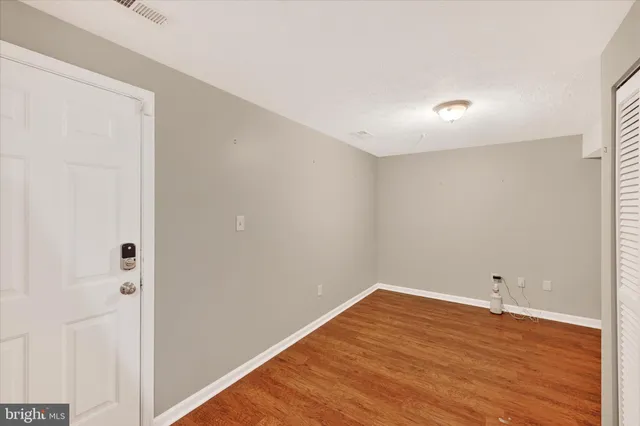 a view of room with wooden floor