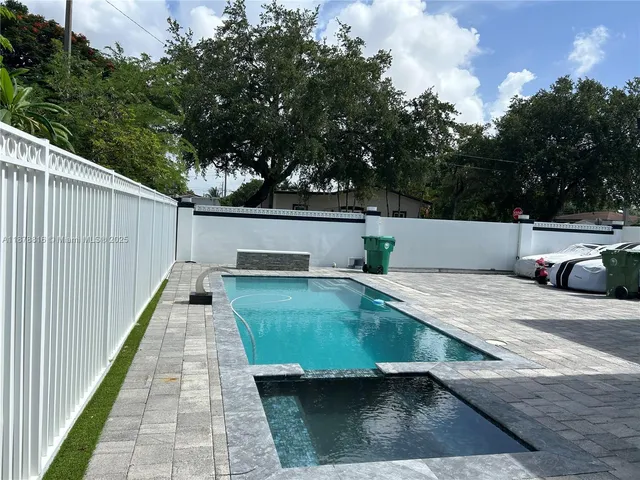 a view of a swimming pool with a patio
