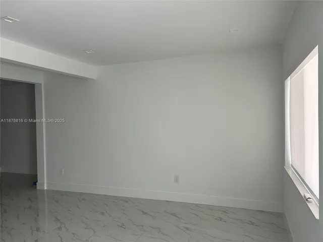 a kitchen with stainless steel appliances kitchen island granite countertop a stove and a refrigerator