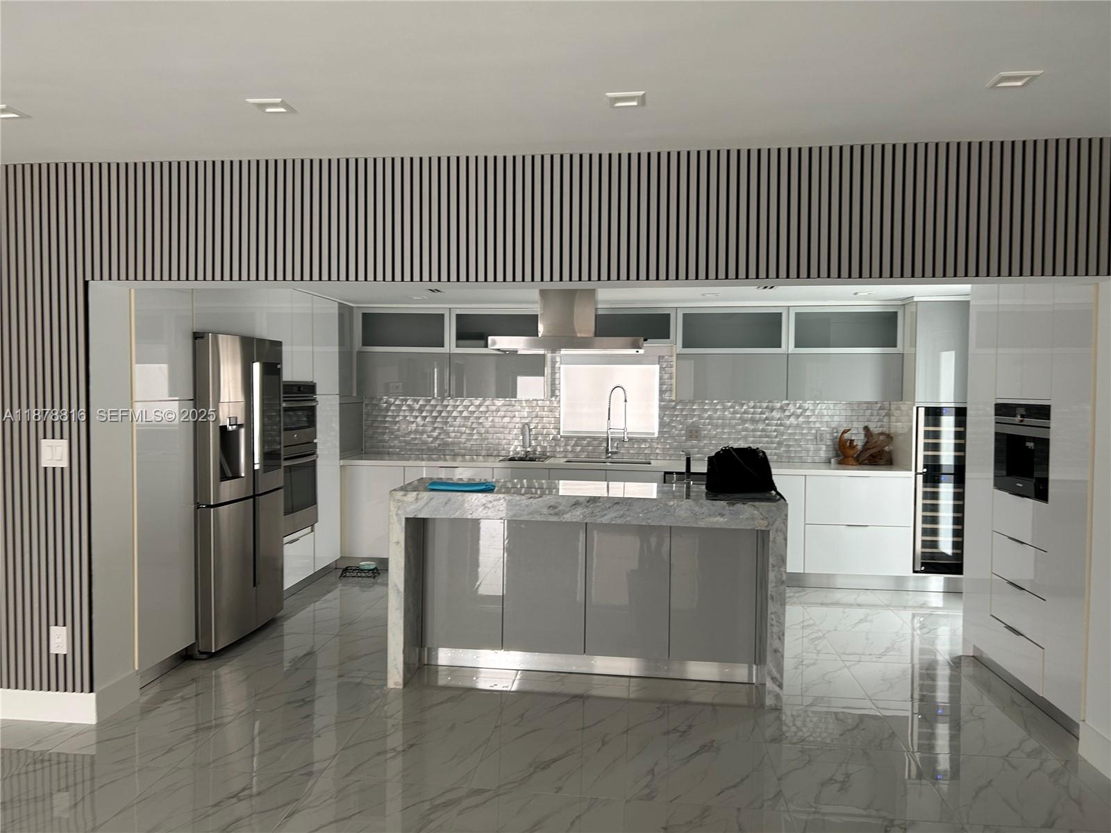 400 Southwest 47th Avenue Miami, FL 33134 - Photo 19 of 55 a kitchen with stainless steel appliances kitchen island granite countertop a stove and a refrigerator