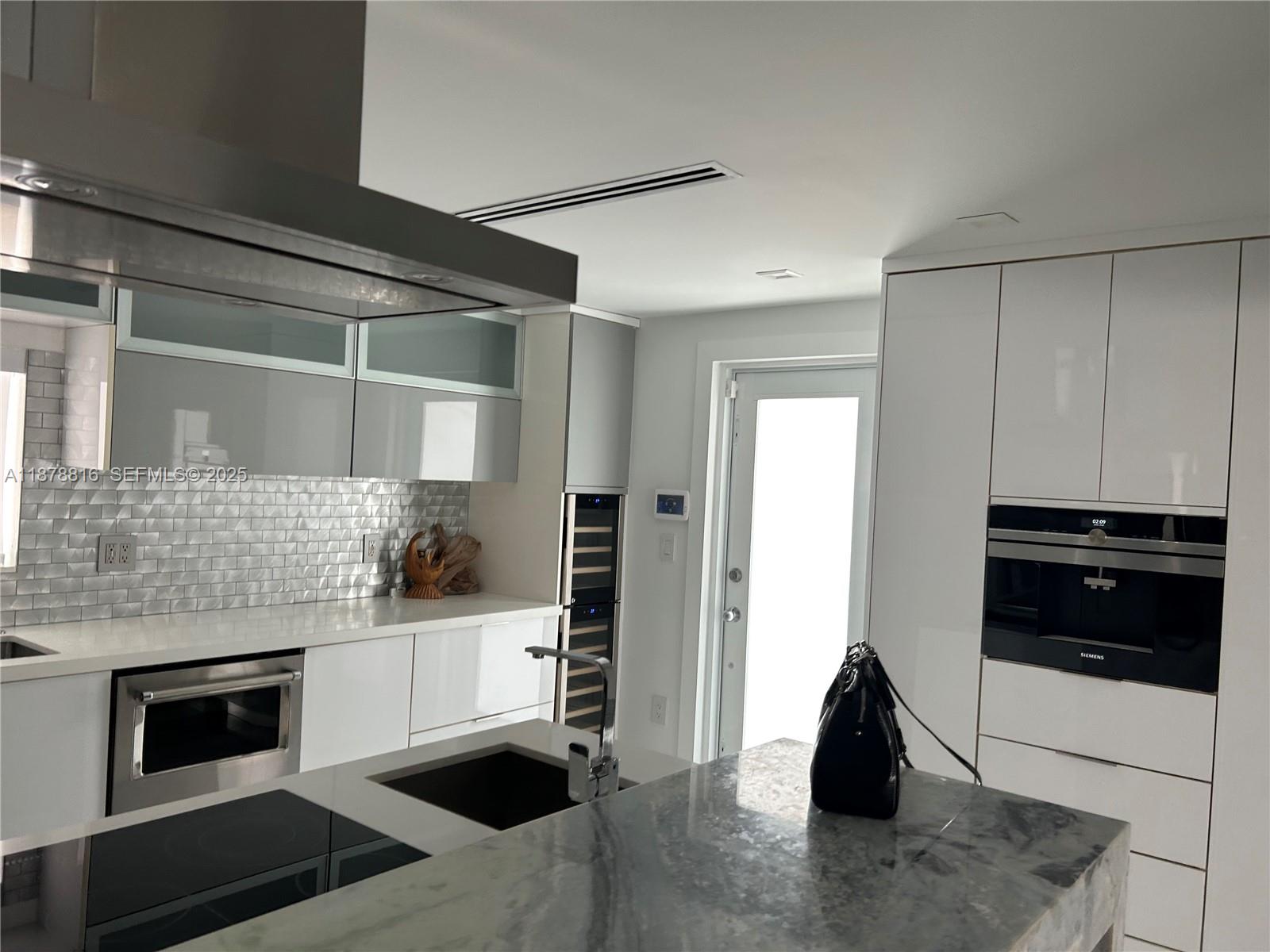 400 Southwest 47th Avenue Miami, FL 33134 - Photo 20 of 55 a kitchen with stainless steel appliances kitchen island a stove and a refrigerator