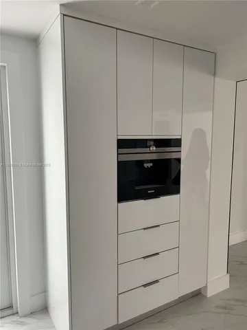 an empty room with a empty space and windows