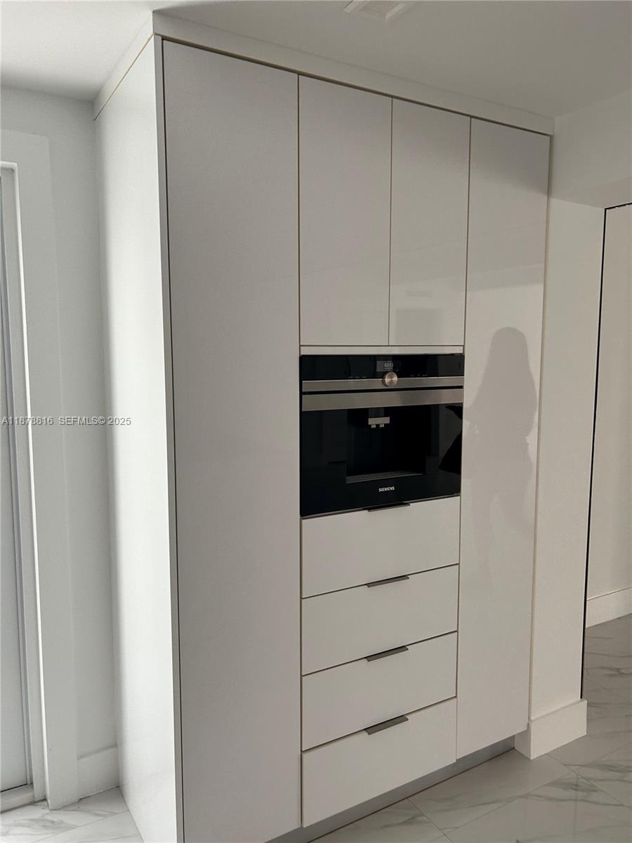 400 Southwest 47th Avenue Miami, FL 33134 - Photo 24 of 55 a kitchen with cabinets and white appliances