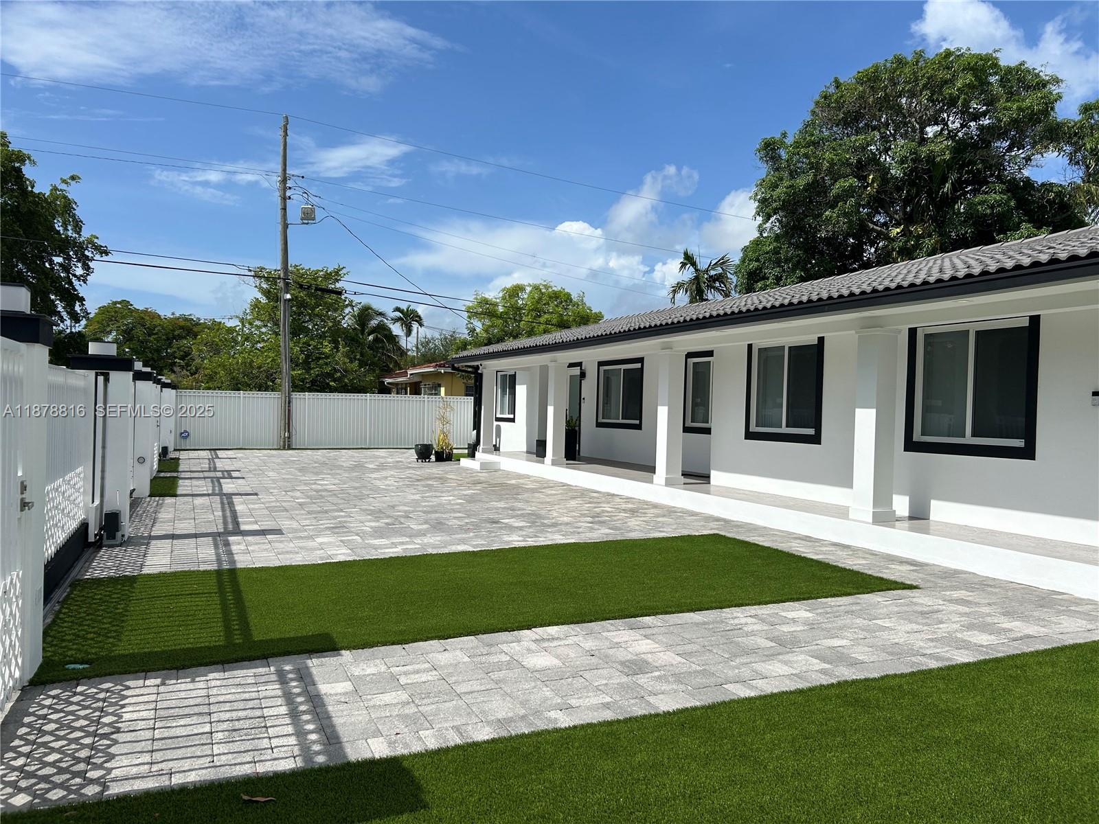 400 Southwest 47th Avenue Miami, FL 33134 - Photo 3 of 55 a view of a house with a backyard and a tree