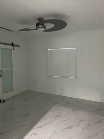 a white toilet sitting next to a shower