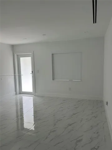 a view of a closet with racks on the wall