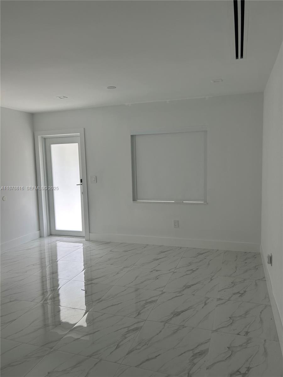 400 Southwest 47th Avenue Miami, FL 33134 - Photo 42 of 55 an empty room with wooden floor and windows