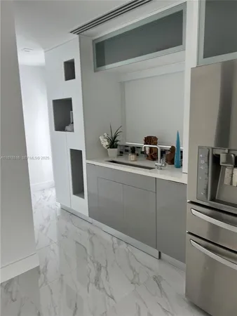 a bathroom with a granite countertop toilet and a sink