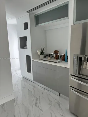 a bathroom with a granite countertop toilet and a sink