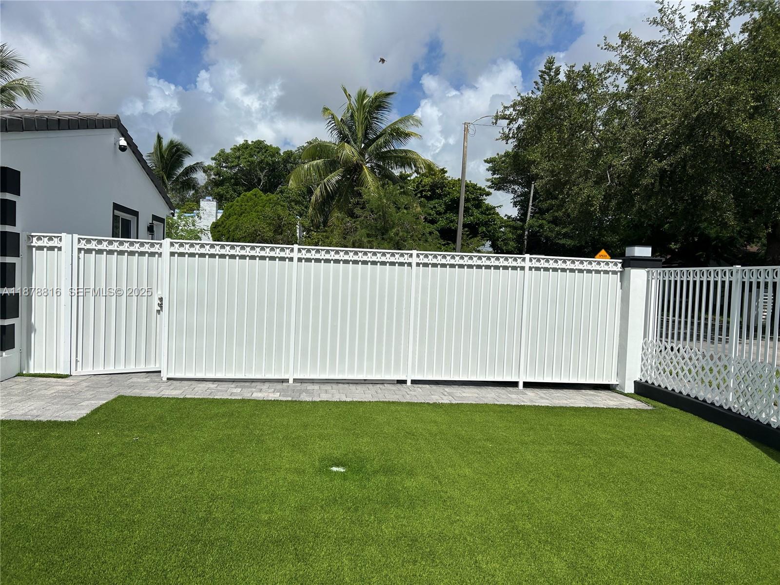 400 Southwest 47th Avenue Miami, FL 33134 - Photo 6 of 55 a white house with green field in front of it