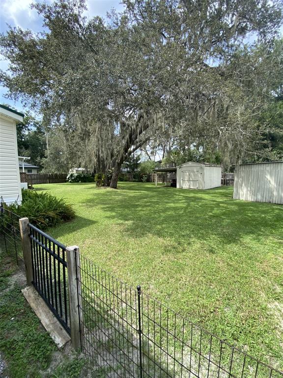 18851 Washington Lane Spring Hill, FL 34610 - Photo 13 of 25 a view of a backyard with wooden fence
