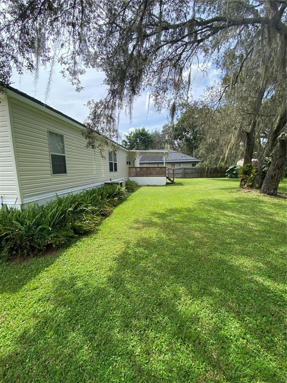 18851 Washington Lane Spring Hill, FL 34610 - Photo 2 of 25 a backyard of a house with lots of green space