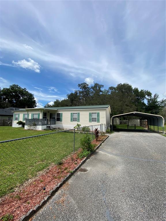 18851 Washington Lane Spring Hill, FL 34610 - Photo 4 of 25 a front view of a house with a yard and garage