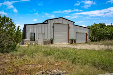 a view of backyard of house with green space