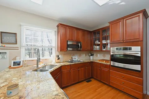 a bathroom with a tub sink shower and a mirror