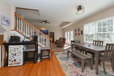 a spacious bathroom with a granite countertop sink mirror and bathtub