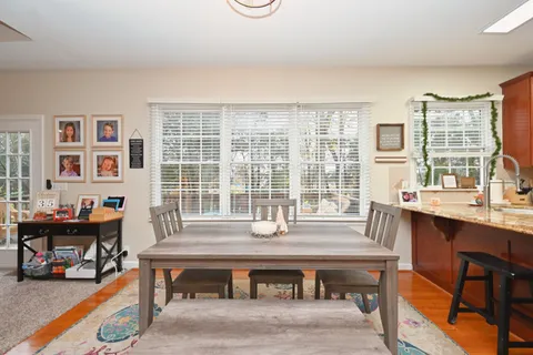 a dining room with a large window table and chairs
