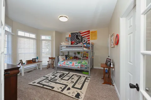 a bedroom with a bed and a large window