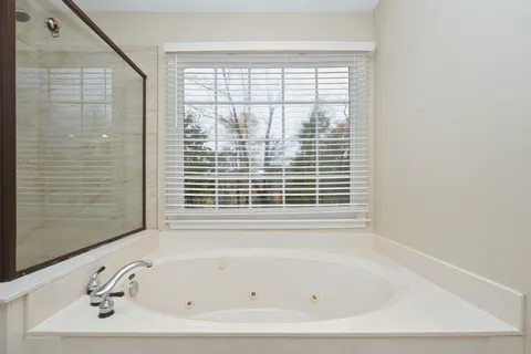 a white bath tub sitting next to a window