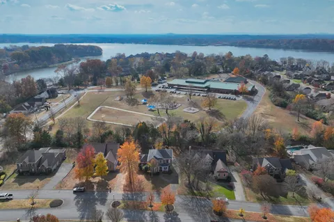an aerial view of residential houses with outdoor space and river