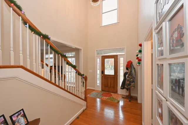 a view of an entryway with wooden floor and stairs