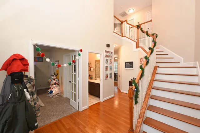 a view of entryway and hall with wooden floor