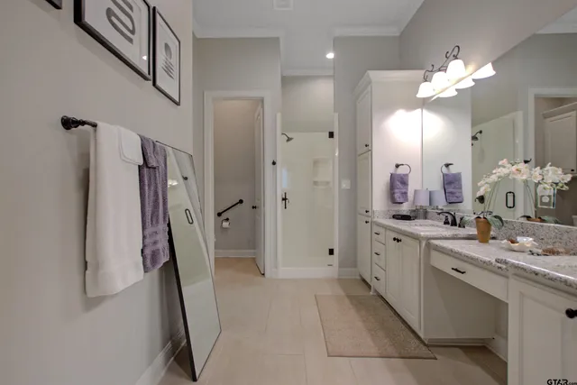 a bathroom with a double vanity sink mirror and shower