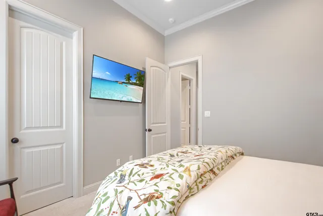 a bedroom with a bed and a painting on the wall