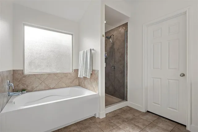a bathroom with a bathtub and a shower