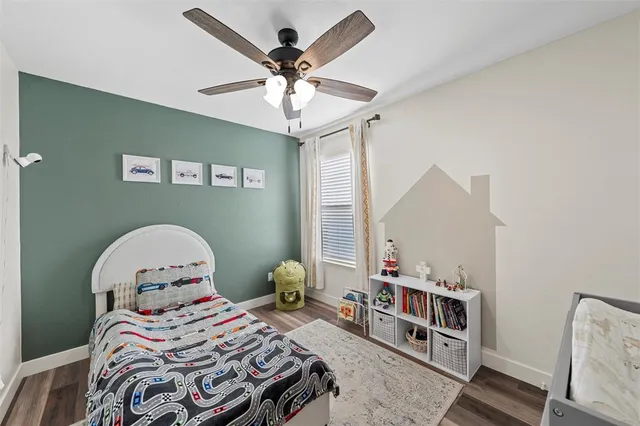 a bedroom with a bed a window and a chandelier