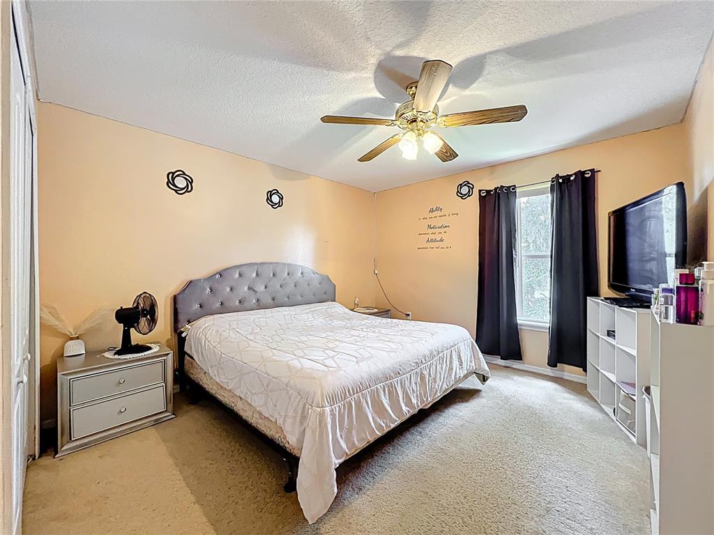 7939 Riffle Lane Orlando, FL 32818 - Photo 34 of 52 a bedroom with a bed and a flat screen tv