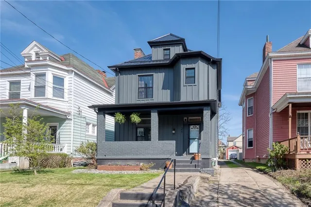 a front view of a house with a yard