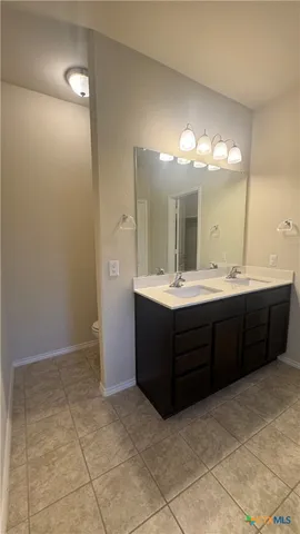 a bathroom with a sink vanity and a mirror