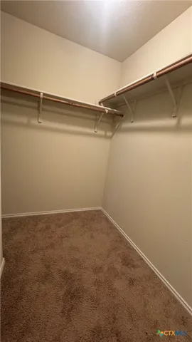 a view of a room with shelf on the wall