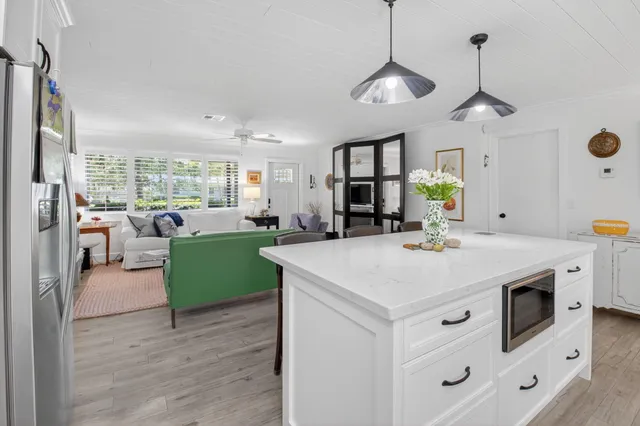 a view of kitchen with windows and refrigerator