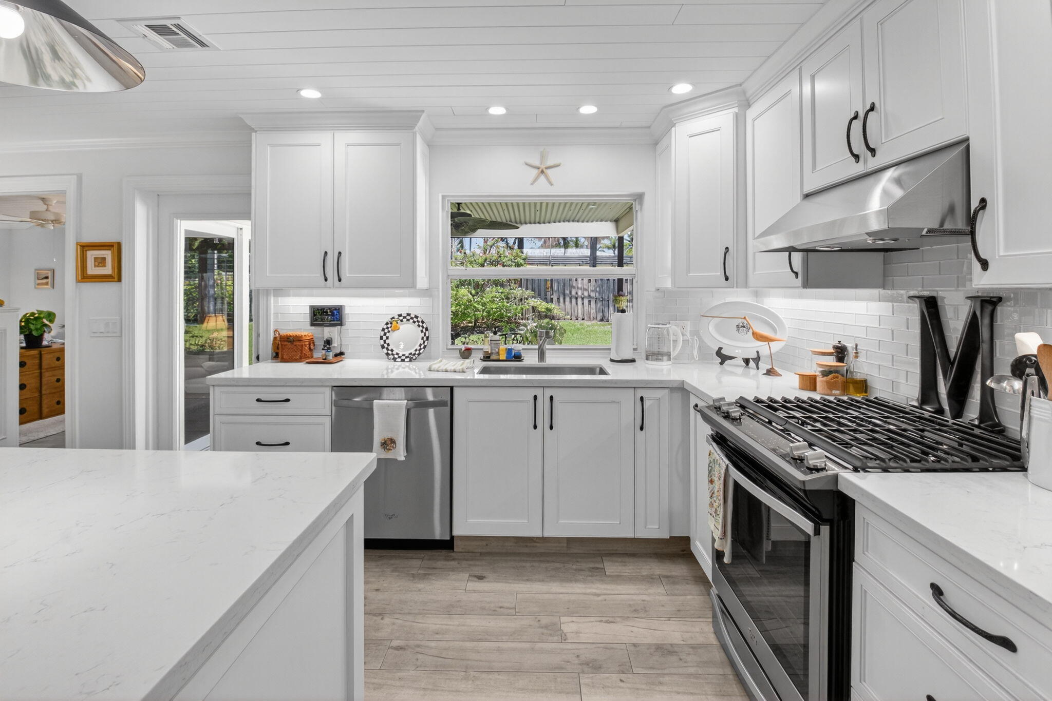 2702 Southwest 6th Street Boynton Beach, FL 33435 - Photo 17 of 49 a kitchen with stainless steel appliances a sink stove and cabinets