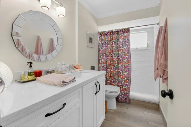 a bathroom with a sink a toilet and a mirror