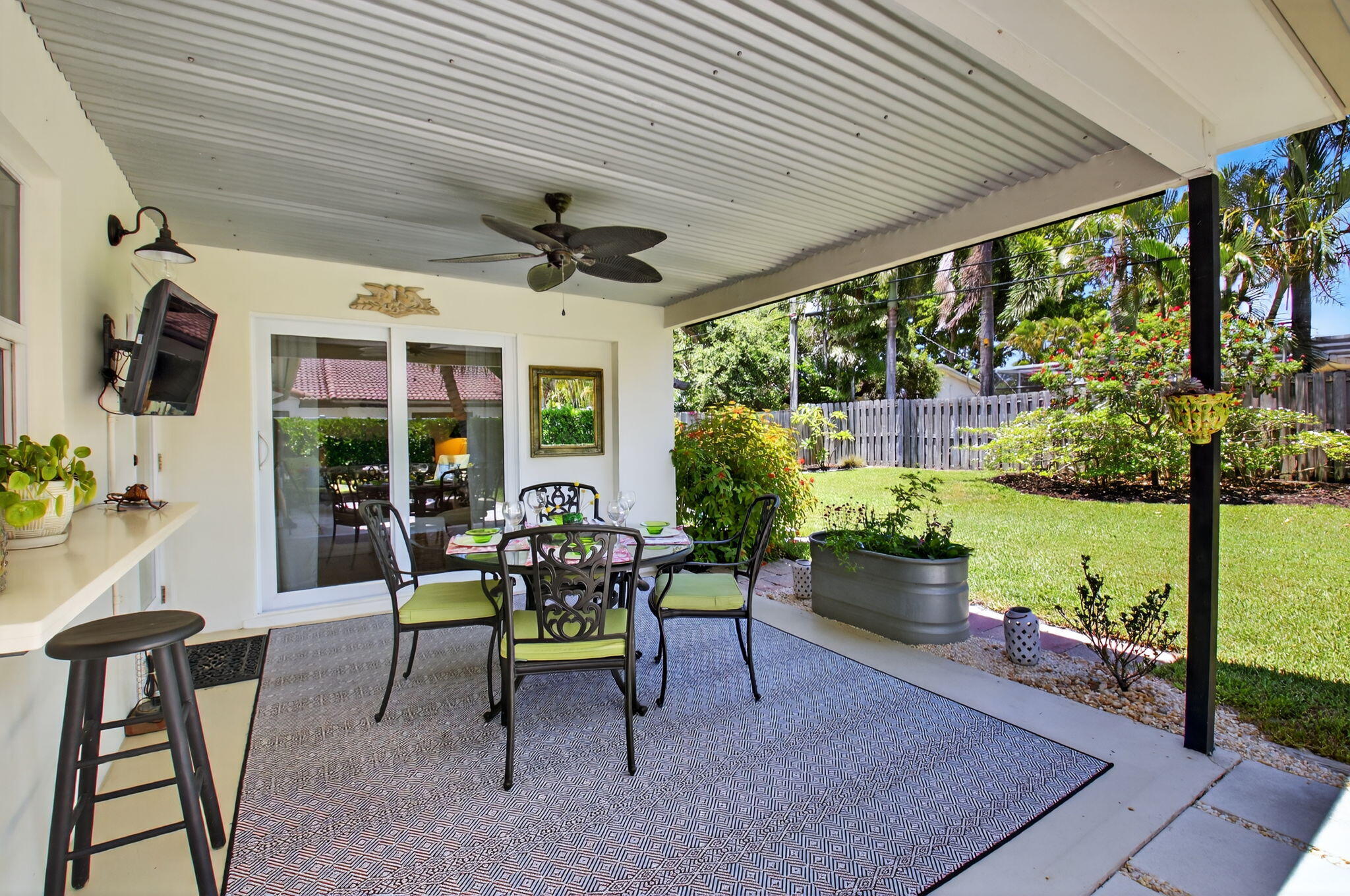 2702 Southwest 6th Street Boynton Beach, FL 33435 - Photo 32 of 49 a view of a porch with furniture and a garden