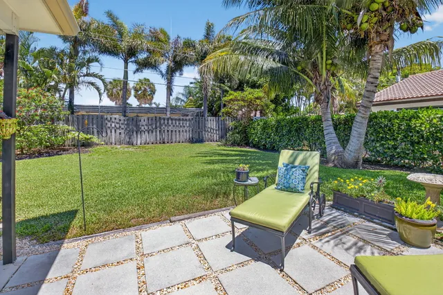 a view of a chair and table in the garden