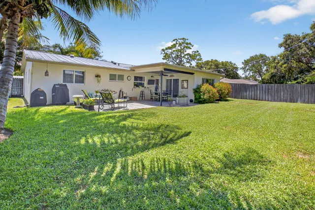 a view of a house with a yard patio and sitting area